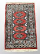 A Lahore Bokhara rug on red ground 101 cm x 65 cm