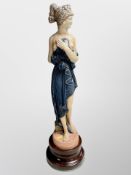 A large ceramic figure of a scantily-clad female,