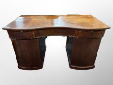 A 19th century mahogany serpentine fronted twin pedestal writing desk,