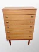 A teak-effect five drawer chest,