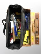 A box of builder's tool bag and contents, hand tools, vintage wooden spirit levels,