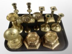 Six pairs of brass candlesticks,