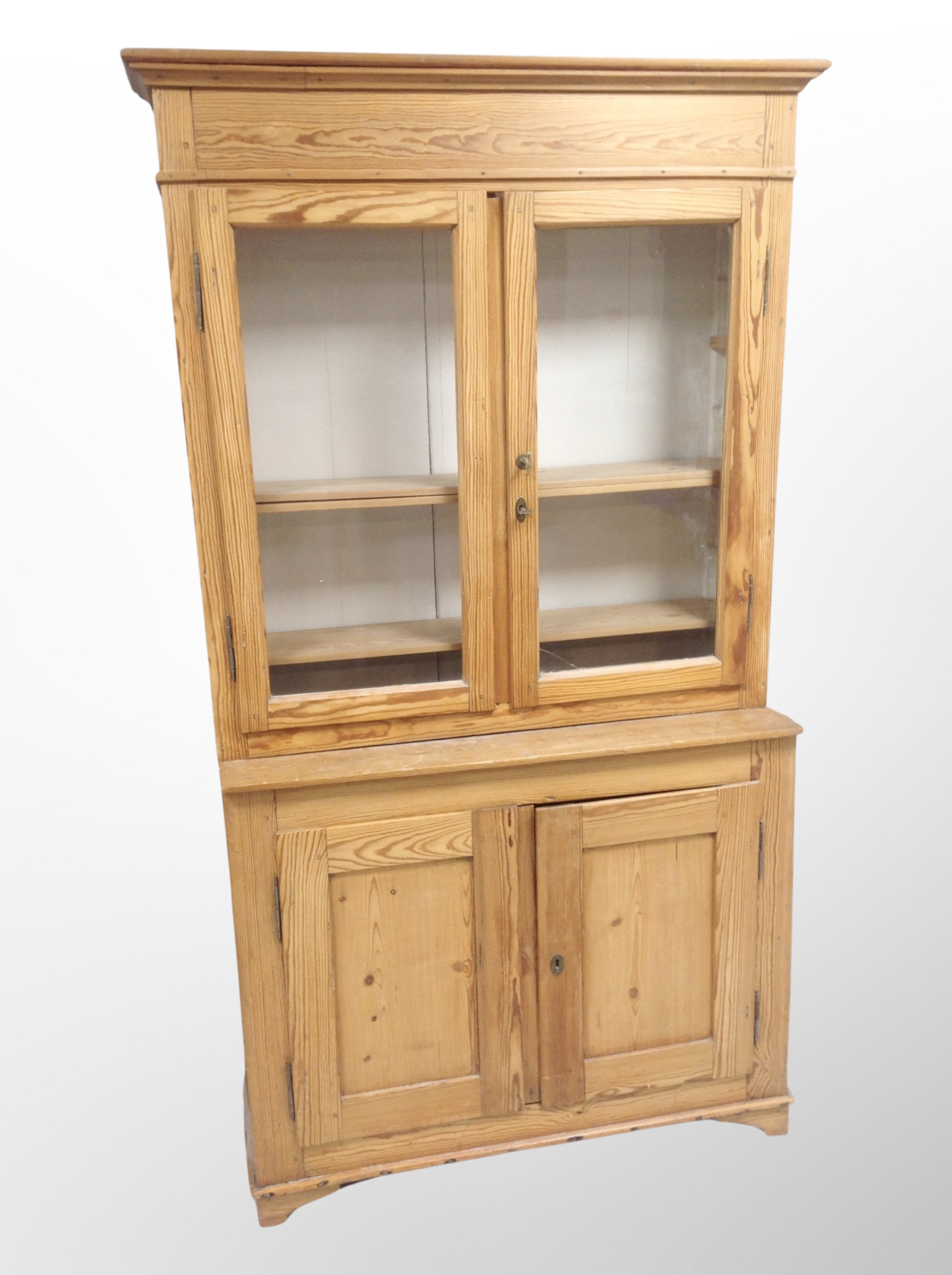 A late 19th century pitch pine glazed bookcase,