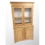A late 19th century pitch pine glazed bookcase,