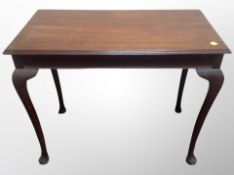 A reproduction mahogany console table on cabriole legs,