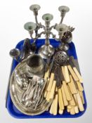 A tray of silver plated and stainless steel candleabrum, cutlery, silver plated dish,