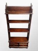 A reproduction mahogany etagère fitted with four drawers,