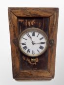 A large nickel cased eight day pocket watch on oak watch stand