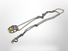 An oval silver pendant set with coloured stones on chain