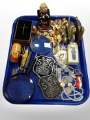 A group of gilt collector's teaspoons, die cast metal plaques, bottle openers, magnifying glasses,