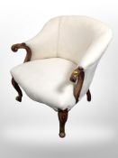 A Victorian style mahogany armchair in beige fabric,
