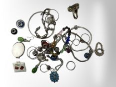 A collection of sterling silver jewellery : locket, dress rings, charm bracelets,