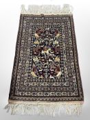 An Afghan Balouch pictorial rug depicting figures hunting on horseback,