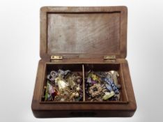 A well carved Eastern hardwood jewellery box containing costume brooches