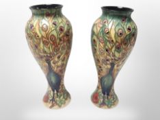 A pair of Moorcroft-style vases with tubelined decoration depicting peacocks,