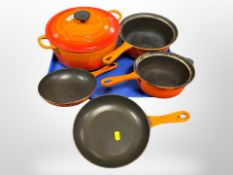 A Le Creuset cast iron lidded pan and four various saucepans