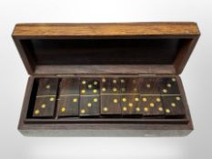 A set of brass inlaid hardwood dominoes in box