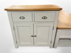 A contemporary oak topped side cabinet fitted with cupboards and drawers,