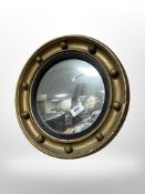 A Regency style gilt porthole mirror,