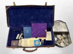 A vintage leather suitcase containing mixed British and foreign coins, crowns, ration books,