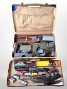 A box and suitcase containing assorted OO gauge rolling stock, railway buildings,