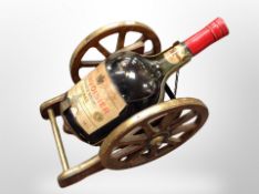 A bottle of Courvoisier cognac on gun carriage plinth,