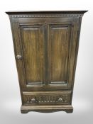 An Ercol stained elm single door cabinet,
