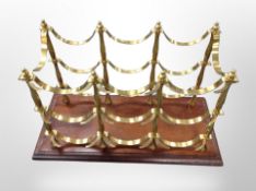 A reproduction mahogany and brass bottle rack,