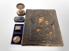 An embossed brass relief icon depicting the Madonna and child,