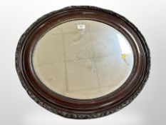 A late Victorian oval framed mirror and a wall shelf