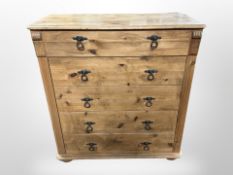 A pine five drawer chest on bun feet,
