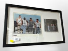 A Blue One Love CD and accompanying photograph, each signed by the band, framed,