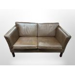 A late 20th century Danish brown leather two seater settee,