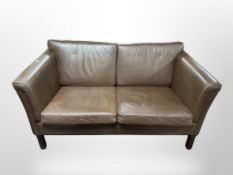 A late 20th century Danish brown leather two seater settee,