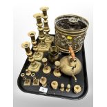 An embossed brass jardiniere on paw feet decorated with cherubs, three pairs of brass candlesticks,