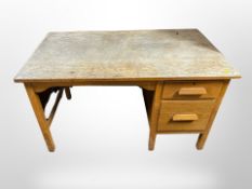 A 1930's oak single pedestal desk width 123 cm