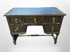 A late Victorian five drawer desk with blue leather inset panel,