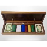 A wooden games box containing playing cards, games counters etc,