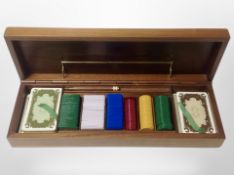 A wooden games box containing playing cards, games counters etc,