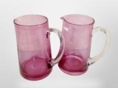 Two Victorian cranberry glass jugs,