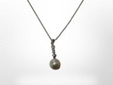A silver and pearl pendant on silver chain