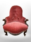 A Victorian carved walnut salon chair in buttoned dralon