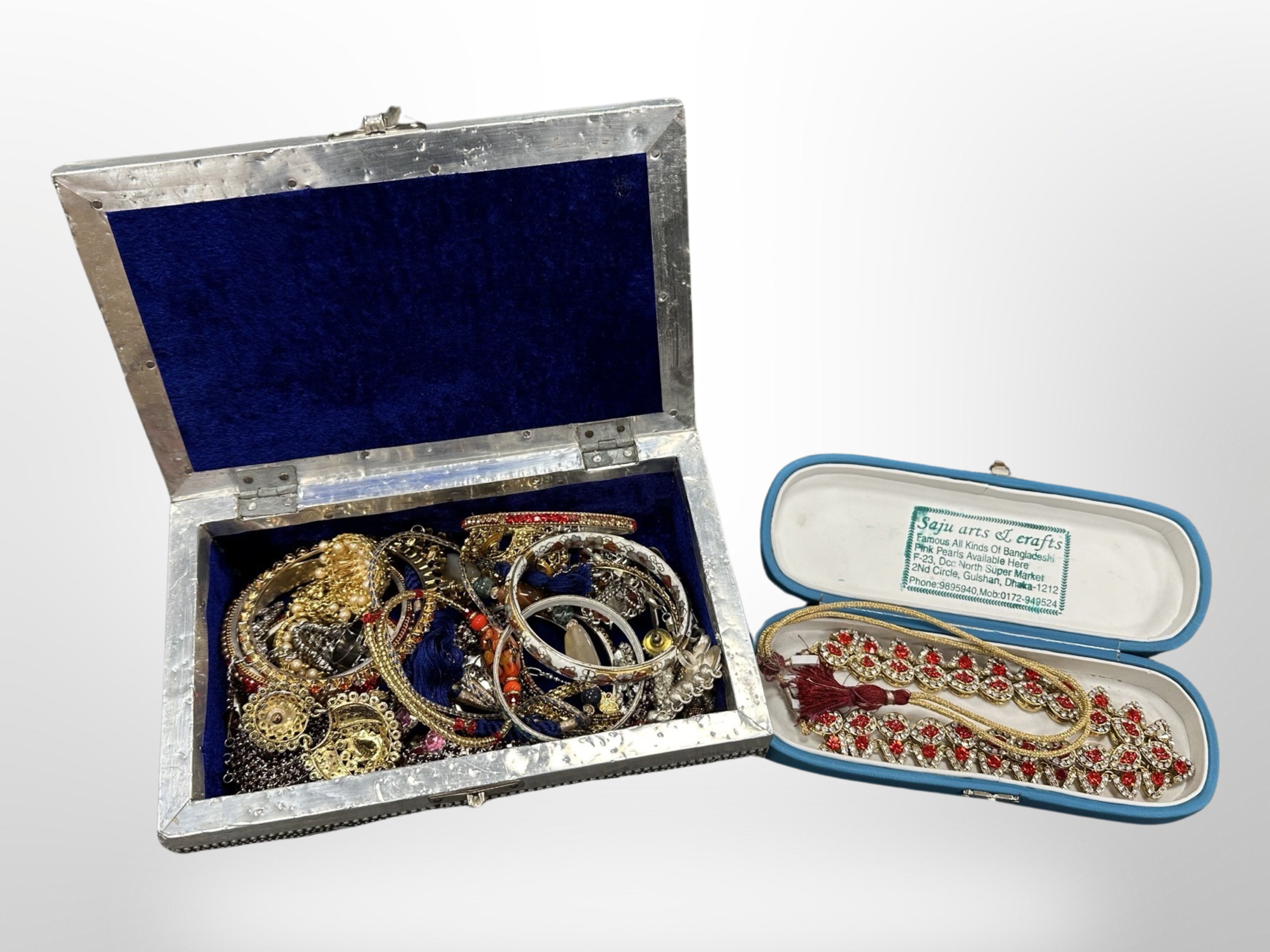 A decorative eastern jewellery box containing costume necklaces, bangles,