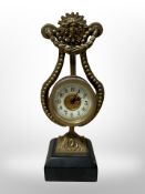 A late Victorian gilt brass lyre-shaped mantel clock,