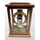 A contemporary German mantel clock with skeletonised movement,