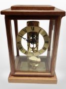 A contemporary German mantel clock with skeletonised movement,