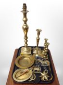 A brass lamp base, pair of brass candlesticks, horse brasses,