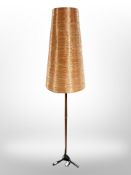 A 1970's teak and cast iron standard lamp with copper-coloured conical shade,