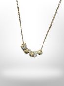 A gilt metal Swarovski necklace with seven beads inset with crystals