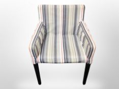 A contemporary armchair in striped upholstery
